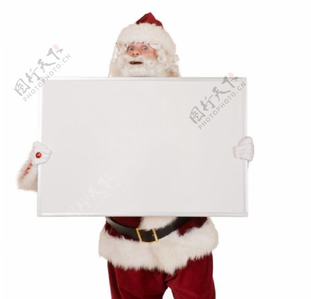 手拿空白广告牌的圣诞老人图片
