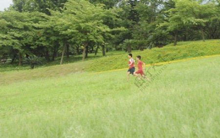 在公园的草场上奔跑的孩子们图片